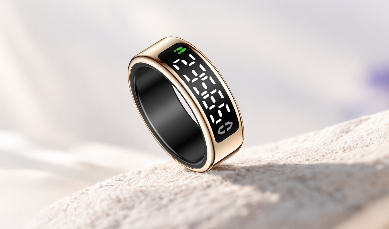 Gold smart ring with its dot-matrix display lit, resting on a white stone surface